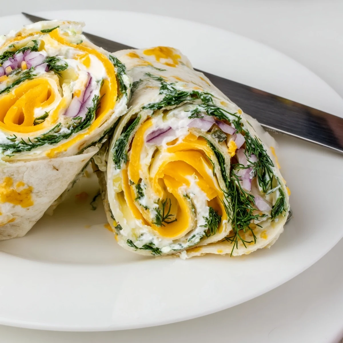 Crispy dill pickles wrapped in soft tortillas and creamy cheese for snacks.  