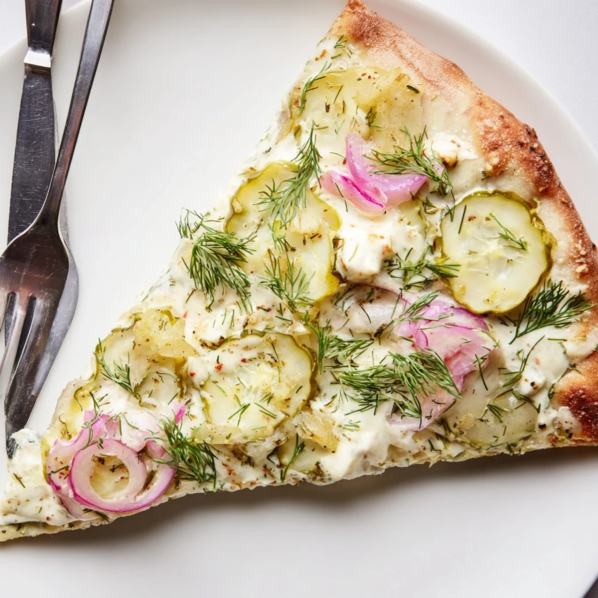 Tangy Pickle Pizza topped with mozzarella and creamy garlic sauce, perfect for sharing.  