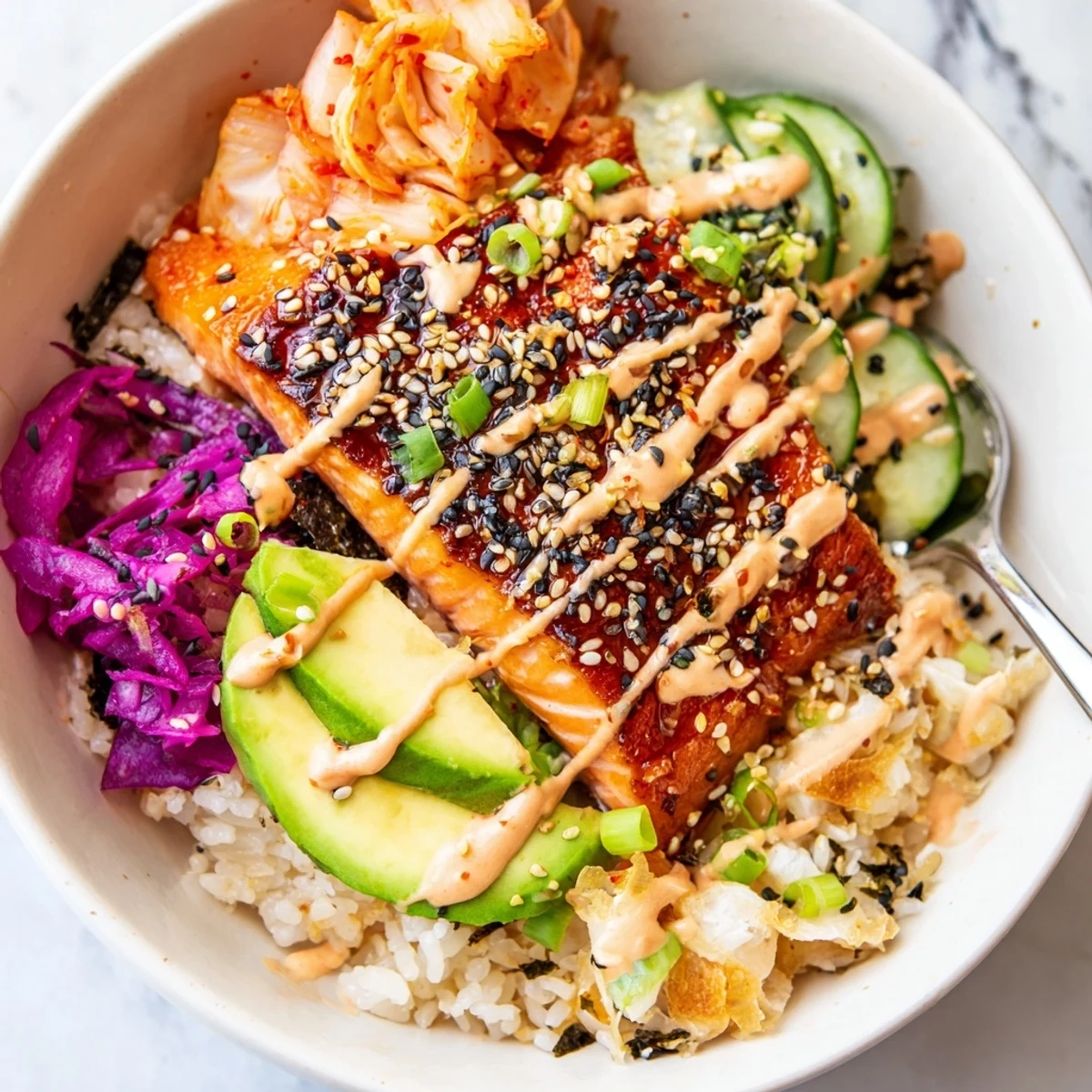 Crispy Salmon Rice Bowl topped with creamy spicy mayo and vibrant kimchi, deliciously colorful.  