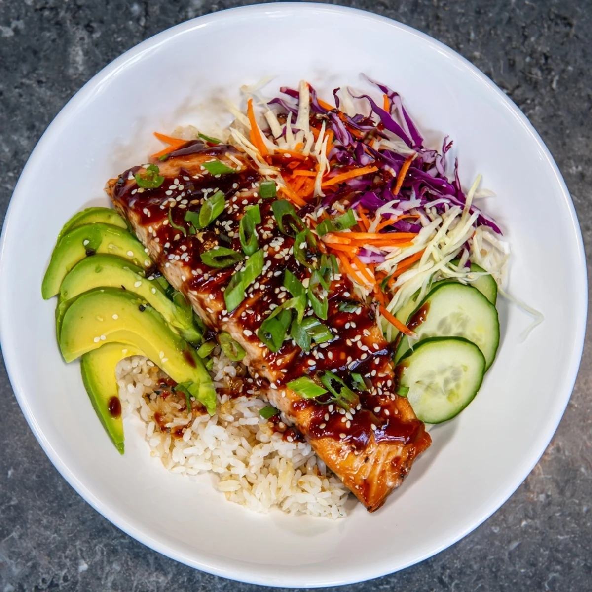 A colorful Sweet Chili Salmon Rice Bowl showcases flaky salmon atop perfectly cooked jasmine rice.