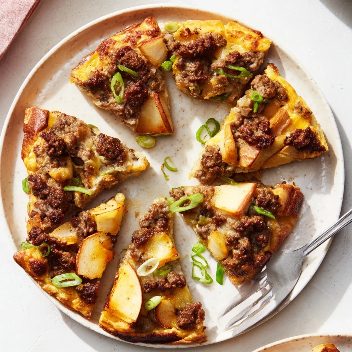 Golden-topped Savory Apple, Sausage, and Cheddar Scone Skillet, served warm, is visually delightful for brunch.