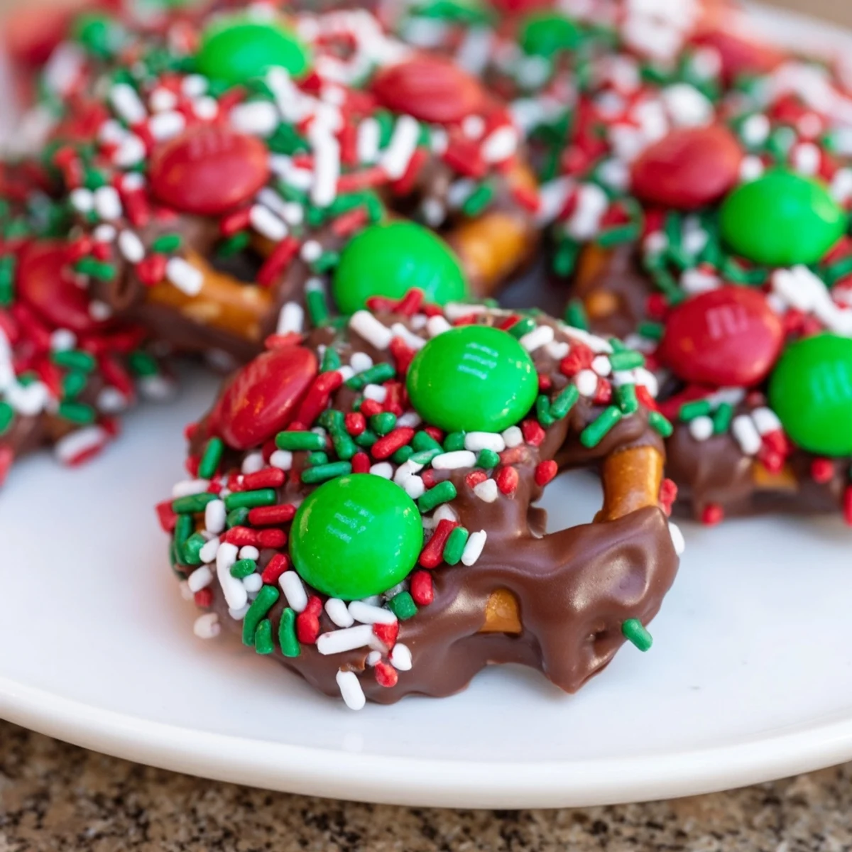 A close-up reveals glossy chocolate on golden Air Fryer Christmas Pretzel Bites, ready for you to savor their delicious flavors.