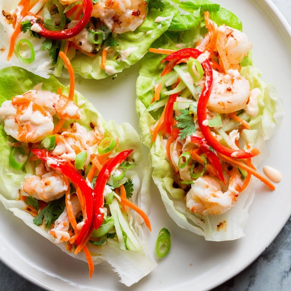 Freshly made shrimp lettuce cups filled with colorful vegetables and savory, tender shrimp for dinner.