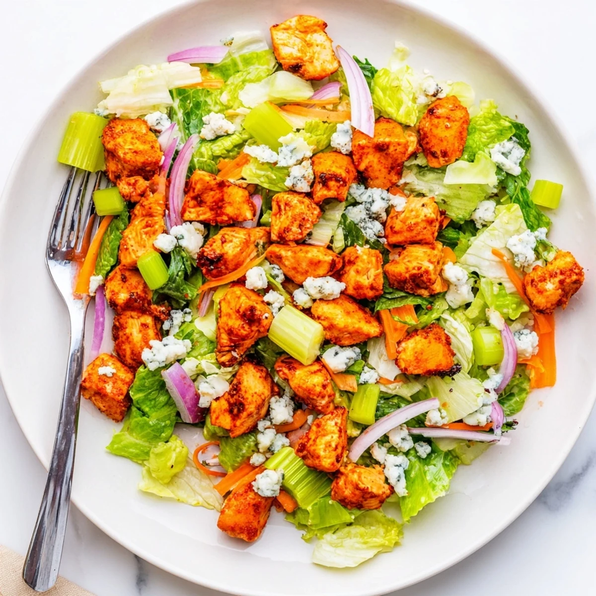 A vibrant Buffalo Chicken Chopped Salad with spicy, saucy chicken, crisp romaine, and creamy blue cheese crumbles.