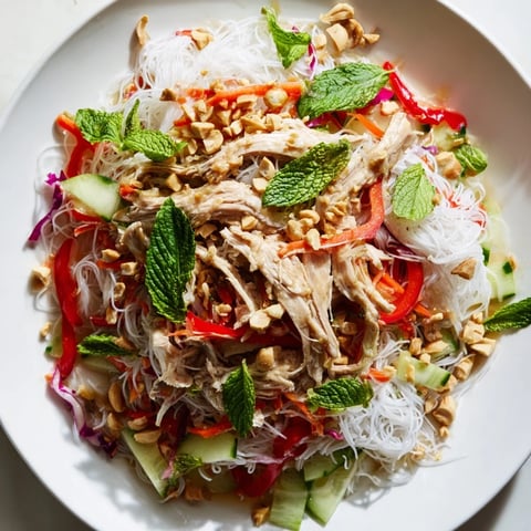 Vietnamese Crunch Noodle Salad with shredded chicken topped with peanuts, a colorful, healthy meal.