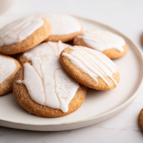 Holiday cookies with icing drizzle: a close-up of golden, round treats with festive, sugary patterns.