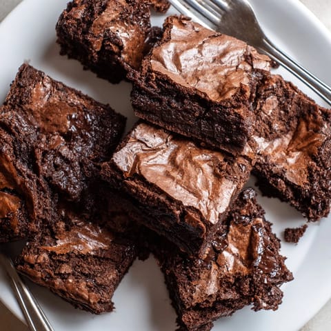 Homemade Fudge Brownies squares, cut and ready to serve, inviting chocolate dessert indulgence.