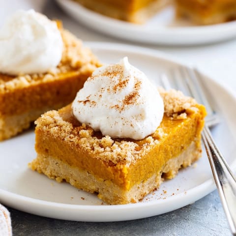 Creamy Pumpkin Pie Bars, spiced and baked until set, ready to slice and serve.