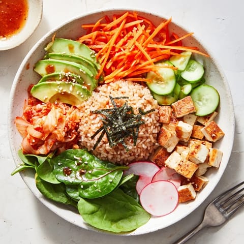 Vibrant Fermented Vegetable Bowl topped with creamy avocado and savory sesame dressing.  