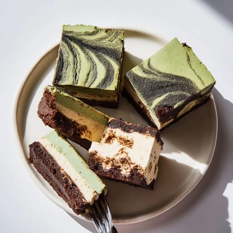 Mini chai tiramisu cups topped with cocoa, exuding aromatic spices and creamy textures.  