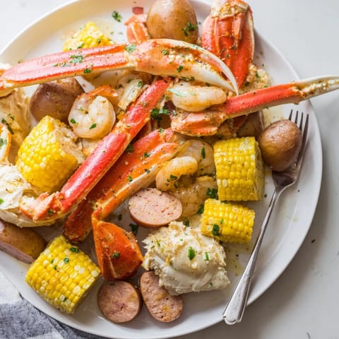 Juicy crab legs and shrimp splashed with melted butter, perfect for sharing.  