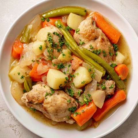 Savor the aroma of a slow-cooked Slow-Cooker Chicken & Vegetable Stew, perfect for a cozy dinner.