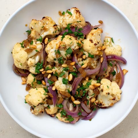 Freshly tossed warm roasted cauliflower with a vibrant, zesty lemon pine-nut dressing.