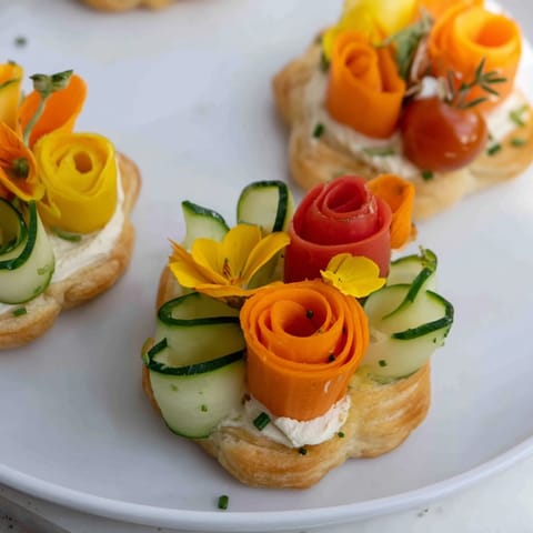 Vibrant Fairy Garden Flower Shaped Snacks with edible flowers, a whimsical treat perfect for a children's party.