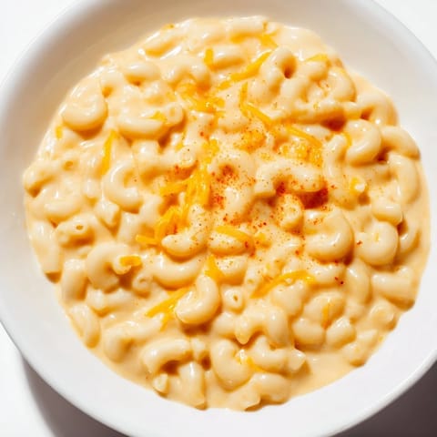 Golden-brown crust on top of a comforting bowl of Tini's Recession Mac, a budget-friendly meal.