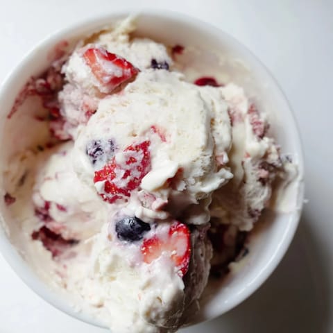 A close-up of thick cottage cheese ice cream, showing vibrant berries and perfect texture.