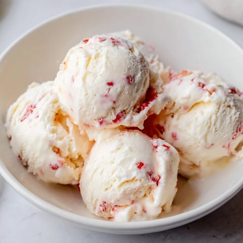 Homemade cottage cheese ice cream with chocolate chips, a sweet treat ready to scoop and enjoy.