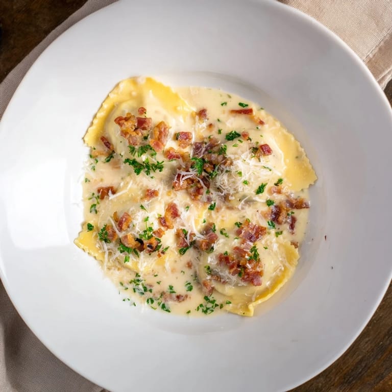 A close-up shot of steaming Olive Garden Ravioli Carbonara, garnished with fresh parsley and Parmesan.