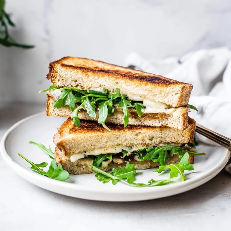 Crispy sourdough surrounds a melty, dreamy Fig, Brie & Arugula Grilled Cheese, perfect for lunch.