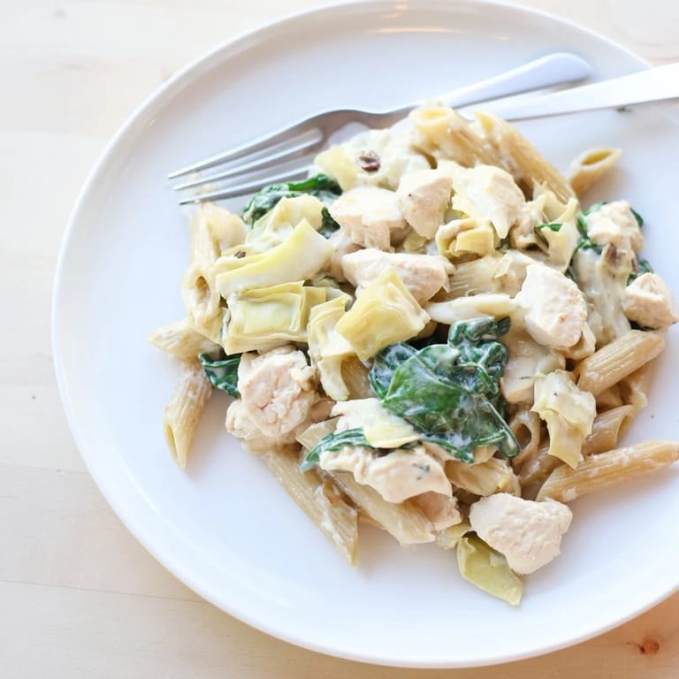 Enjoy a steaming plate of Creamy Spinach Artichoke Protein Pasta Skillet, a flavorful, quick, easy main dish.