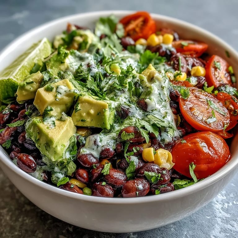Colorful Black Bean and Veggie Bowl topped with cilantro and pumpkin seeds, served as a healthy vegetarian main dish.