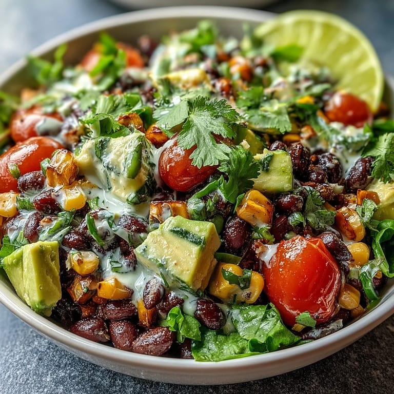 Close-up of a vibrant Black Bean and Veggie Bowl featuring corn, beans, and red onion on a rustic table.